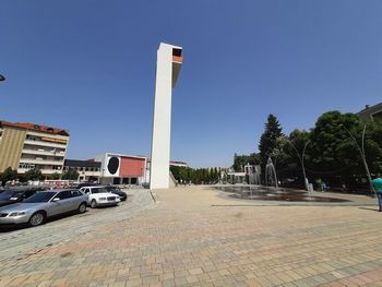 Cars on road against clear blue sky