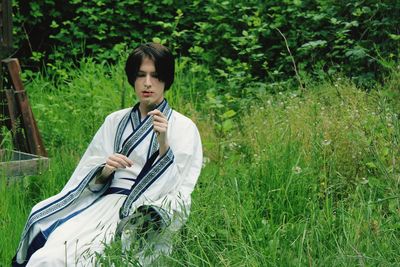 Son beautifully posing in the grass