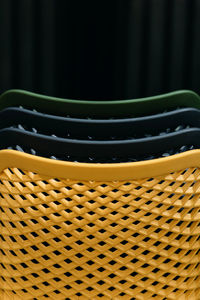 Close-up of colorful stacked chairs.