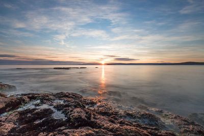 Scenic view of sea against sky at sunset