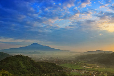 Scenic view of mountains against blue sky