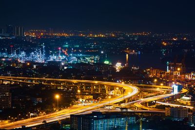 High angle view of illuminated city against sky at night