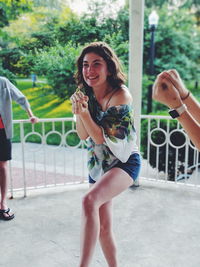 Young woman laughing while dancing on floor