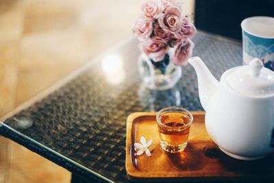 Close-up of tea by teapot on table