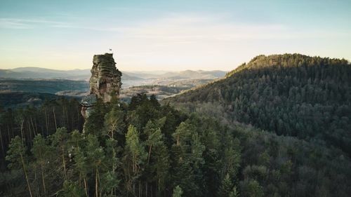 Panoramic view of trees and mountains against sky