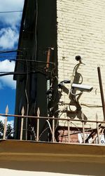 Low angle view of bicycle on wall against building