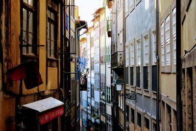 Clothes drying on alley amidst buildings in city