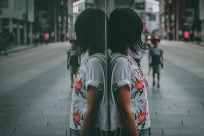 Rear view of women walking on road