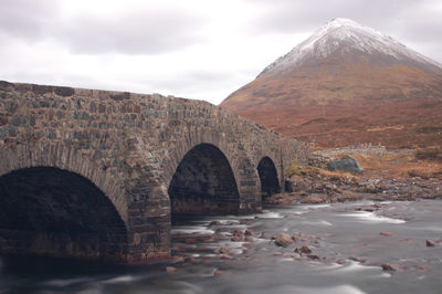 View of stone bridge leading to mountain