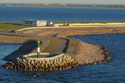 High angle view of groyne by sea against sky