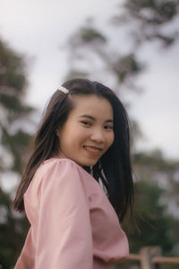 Portrait of smiling girl standing outdoors