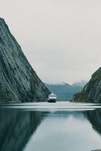 Scenic view of sea and mountains against sky