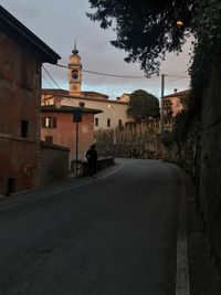 Road amidst buildings against sky in city