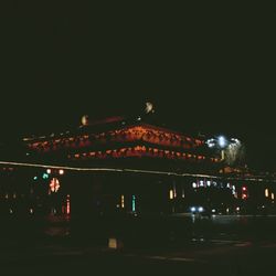 Illuminated city against sky at night