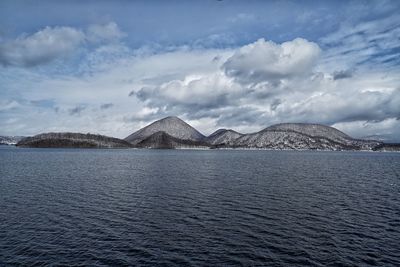 Scenic view of mountains against cloudy sky