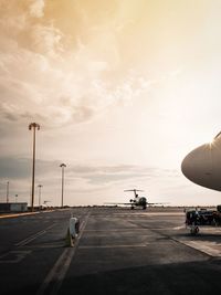 Airplane on runway against sky