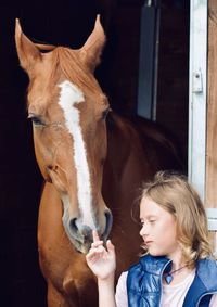 Portrait of woman in stable