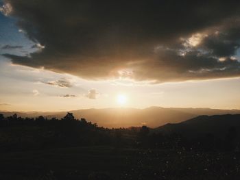 Scenic view of silhouette mountains against sky at sunset