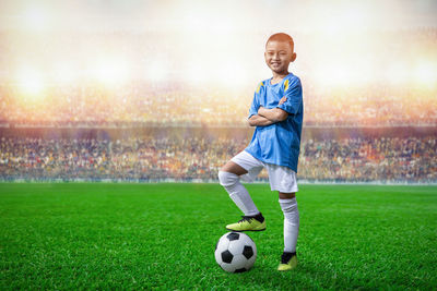 Boy playing soccer on field