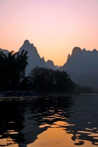 Scenic view of silhouette mountains against sky at sunset