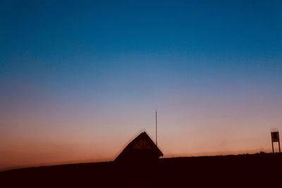 Silhouette of building against sky during sunset