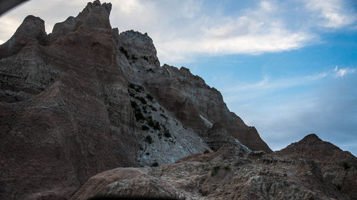 Low angle view of rocky mountain against sky