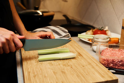 Woman cuts celery slices