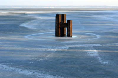 Wooden posts on beach