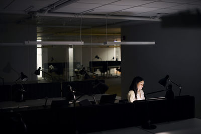 Woman working late in office