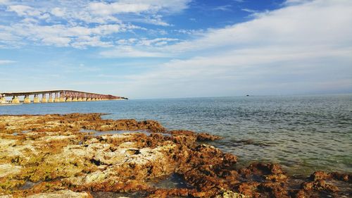 Scenic view of sea against cloudy sky