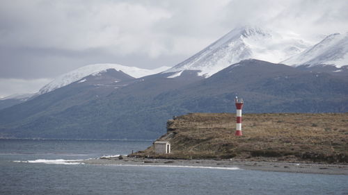 Scenic view of snowcapped mountains and sea against sky