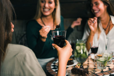 Smiling young woman drinking glass