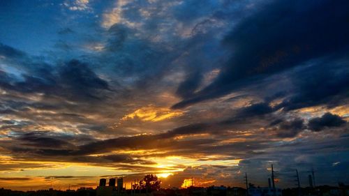 Dramatic sky over city at sunset