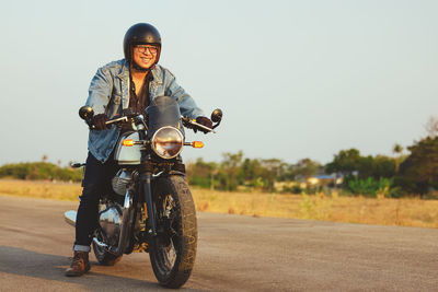 Young man riding big bike motocycle on asphalt high way against, motorbike man has freedom