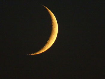 Low angle view of half moon against sky at night