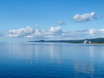 Scenic view of sea against blue sky