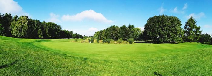 Panoramic view of golf course against sky