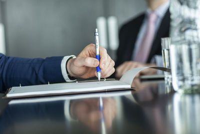 Midsection of woman working on table