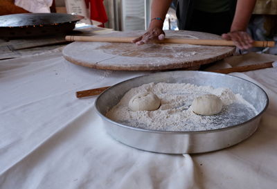 Cropped hand of chef preparing food on table