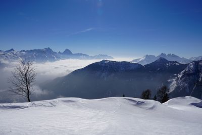 Scenic view of snow covered mountains against sky