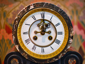 Close-up of clock against wall