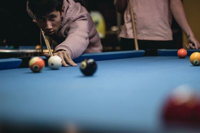 Portrait of boy playing pool