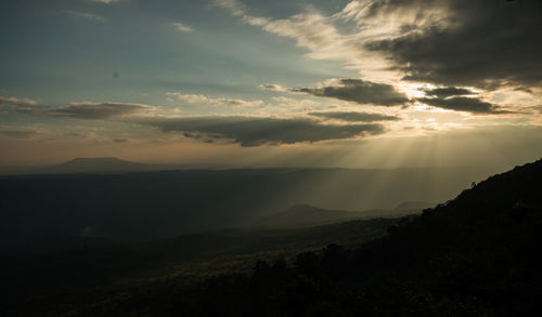 Scenic view of silhouette mountains against sky at sunset