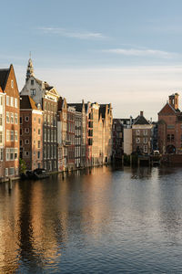 Historical buildings of amsterdam in the sunset light.