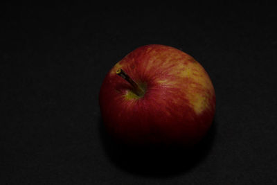 Close-up of apple against black background