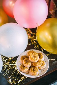 Close-up of dessert and balloons on table