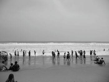 People on beach against sky