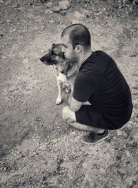 Man with dog sitting outdoors