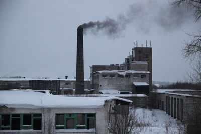 Factory against sky during winter