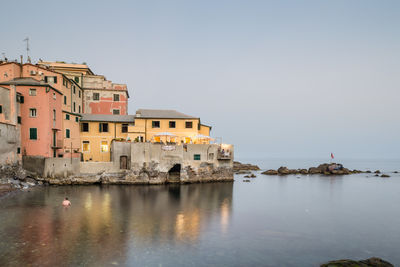 Calm sea with buildings in background